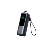Anker 25K 165W power bank in black with digital display showing 100% and retractable USB-C cable extended