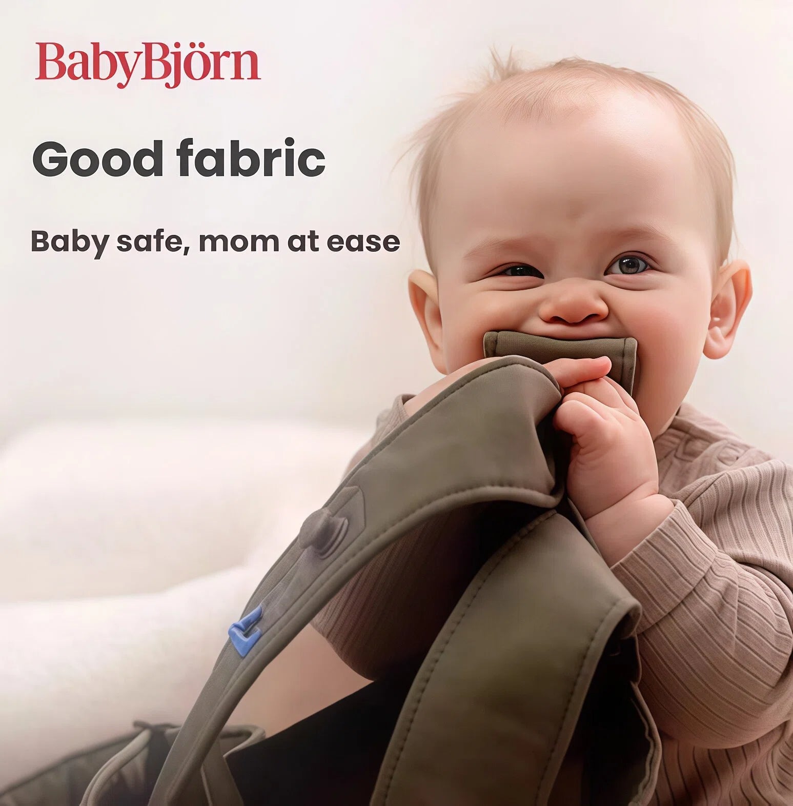 Baby chewing on BabyBjörn Carrier One Cotton strap – OEKO-TEX certified fabric, non-toxic, safe for infants, and gentle on sensitive skin.