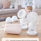 Philips Avent breast pump kit displayed on wooden table with motor unit, bottles, caps, and text highlighting automatic shutdown after 30 minutes of inactivity for safety.
