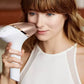 Image of a handheld IPL (Intense Pulsed Light) hair removal device in a sleek white and rose gold design. The device comes with three interchangeable attachment heads for different body areas, each designed with specialized treatment windows. The attachments are color-coded for easy identification and suited for face, body, and precision areas