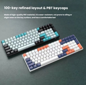 Two Royal Kludge RK100 keyboards displayed side by side — one in black with blue accents, the other in white with orange and purple keys. Both feature a 100-key refined layout with high-quality PBT keycaps that resist wear and oiling, offering a premium typing experience.