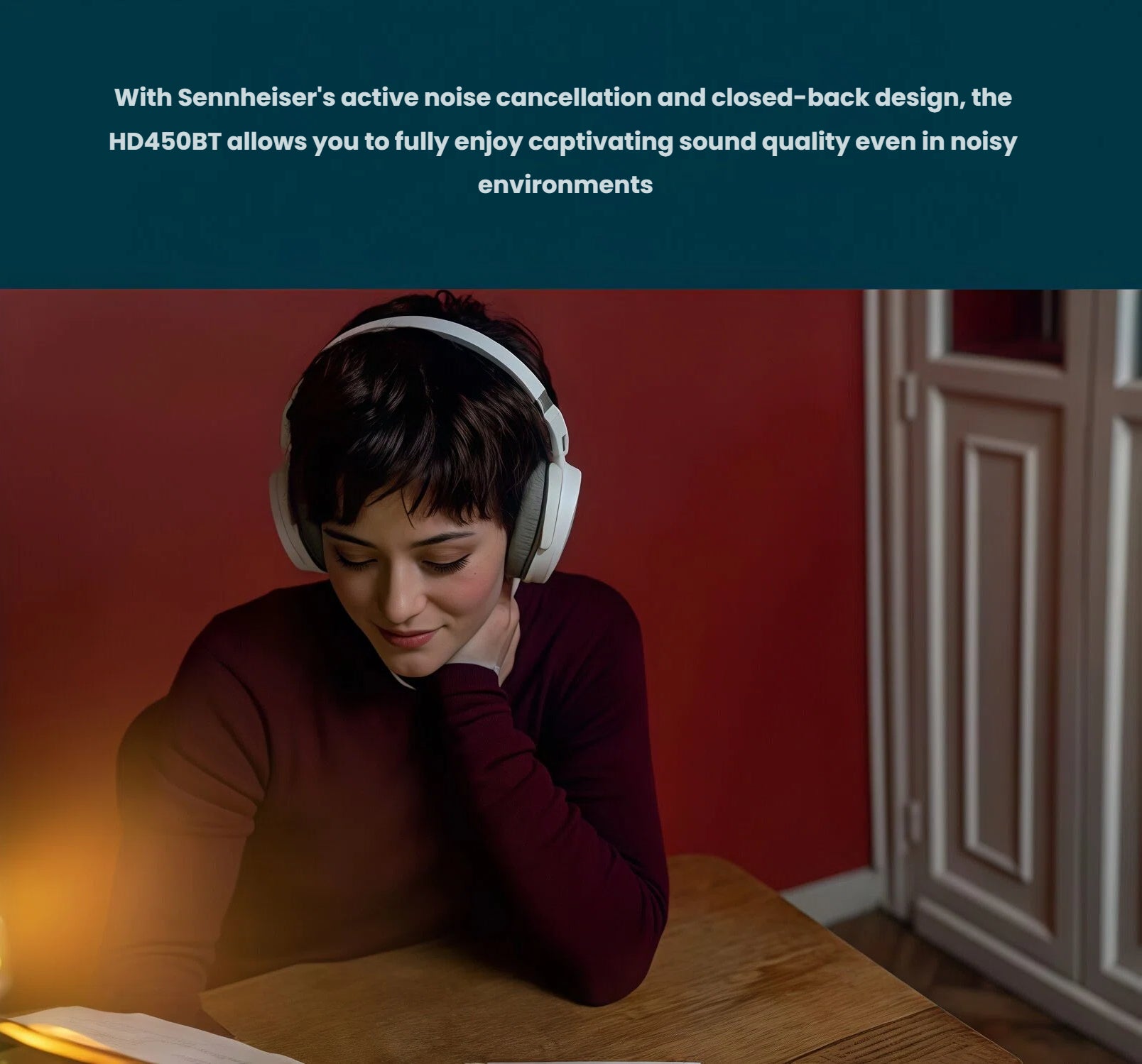 Woman studying with Sennheiser HD 450BT closed-back noise-canceling headphones in a quiet indoor environment
