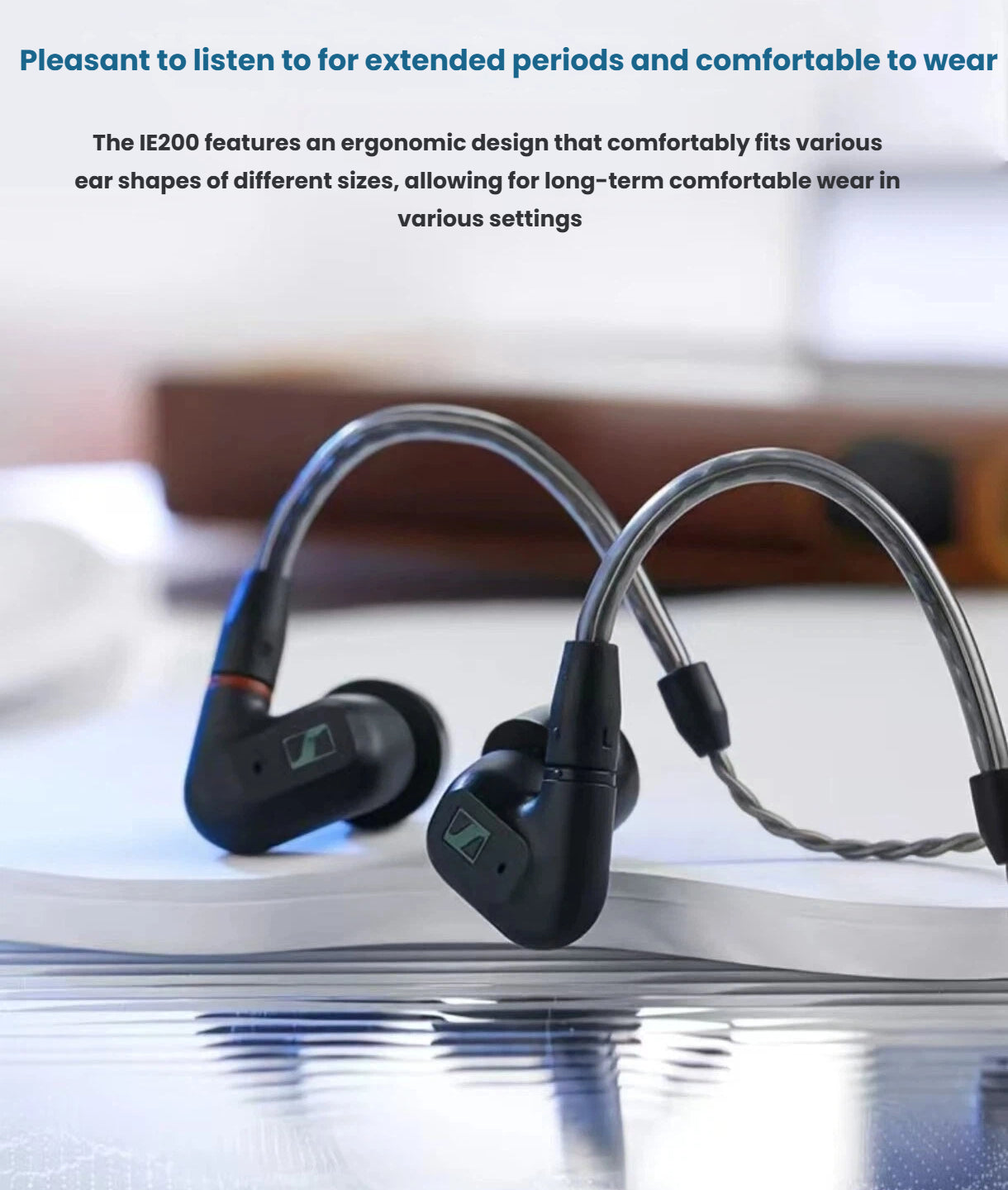 Sennheiser IE 200 earphones displayed on a reflective surface — ergonomic design ensures comfortable fit for extended listening sessions in any environment.
